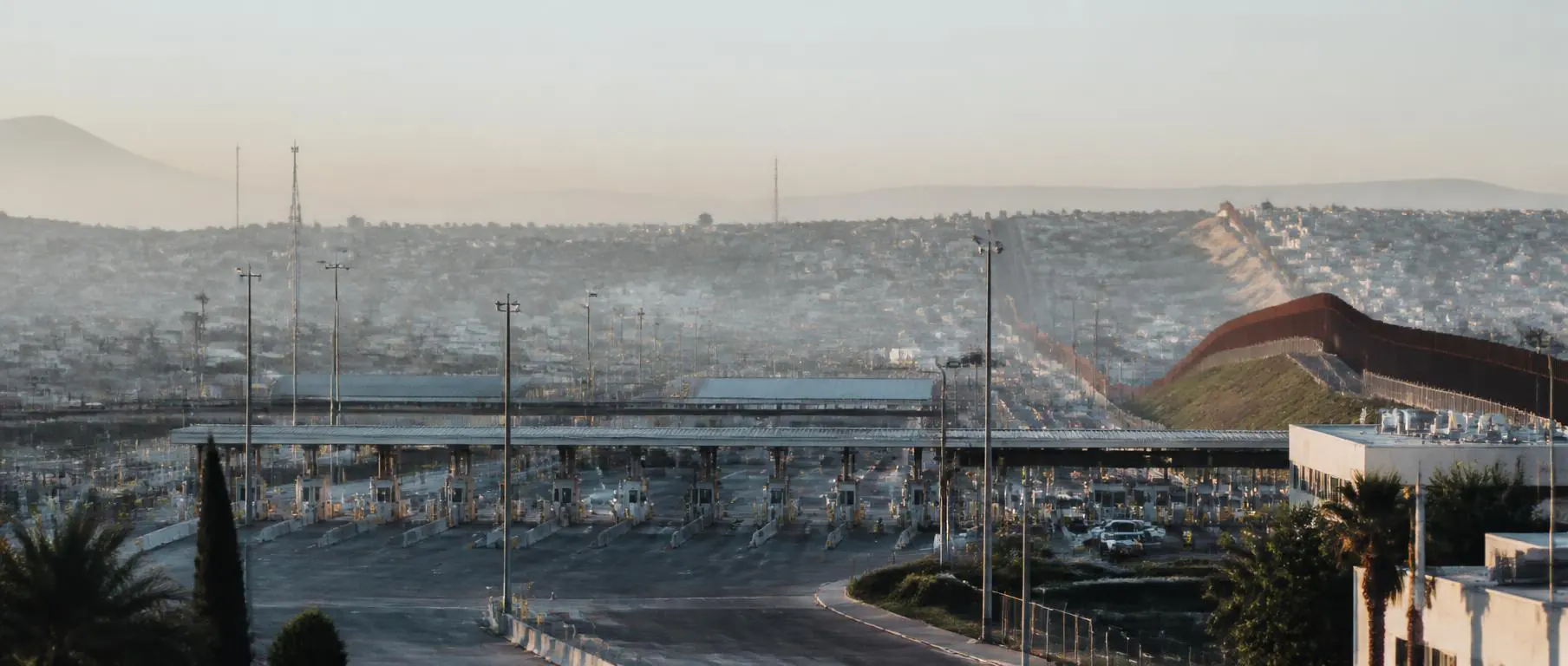 The Mexico–United States border crossing at soft morning light.