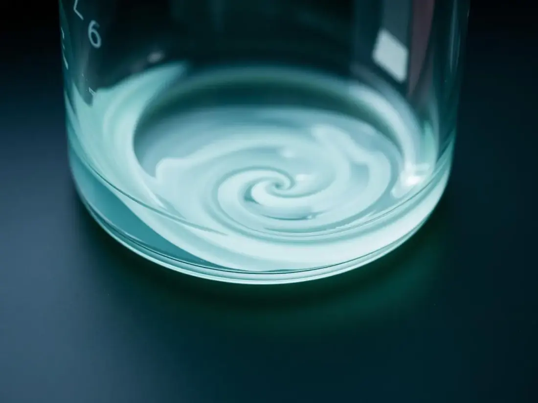 Macro study of clear liquid swirling in a laboratory beaker