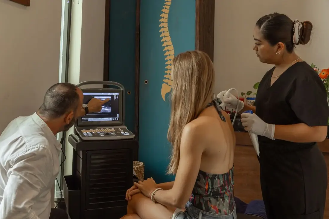 Physician and clinician reviewing a diagnostic ultrasound with a patient