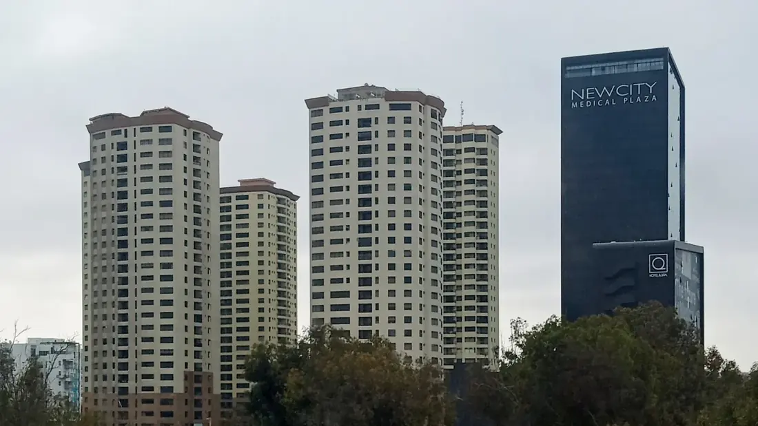The Zona Río medical district in Tijuana, with the New City Medical Plaza tower and surrounding high-rise buildings.