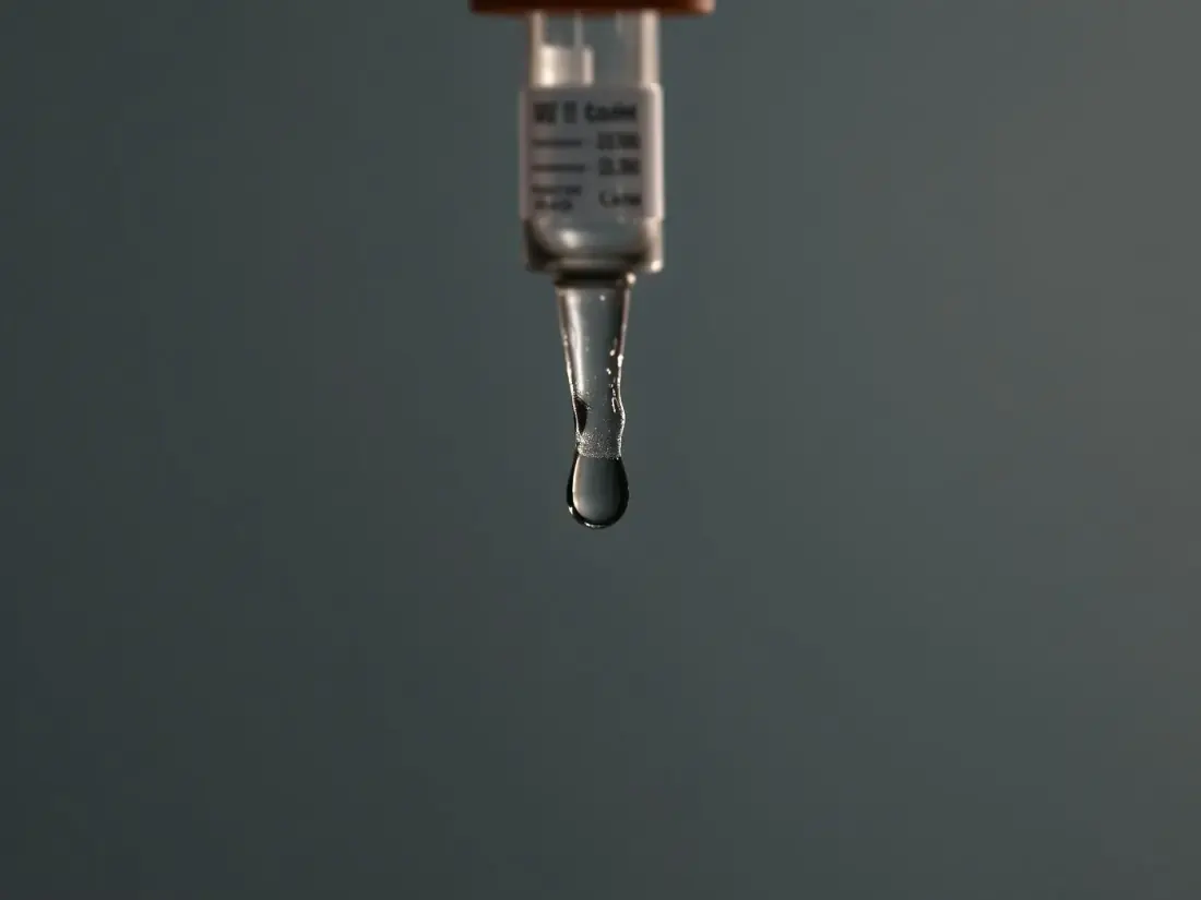 Macro detail of an intravenous line resting on pale linen