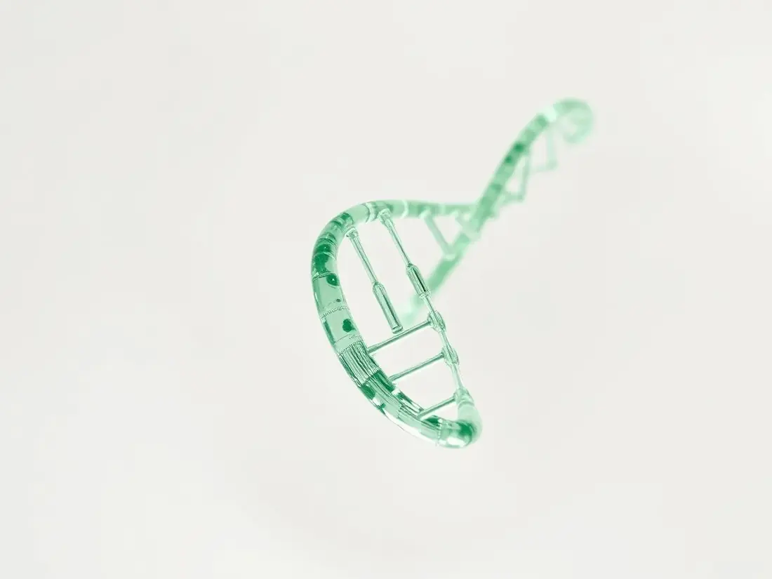 Abstract sage-green DNA double helix rendered in glass and light